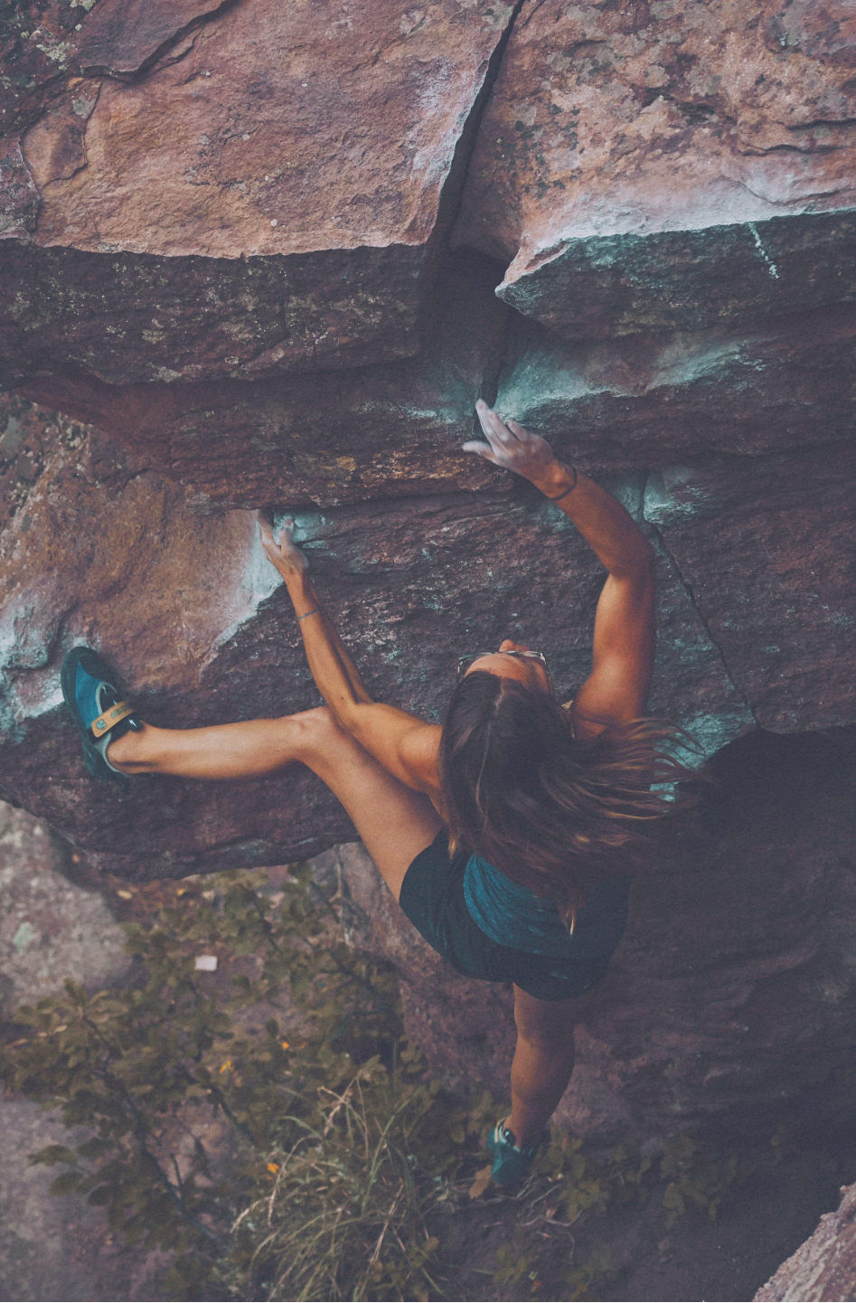 Person climbing a rocky cliff face